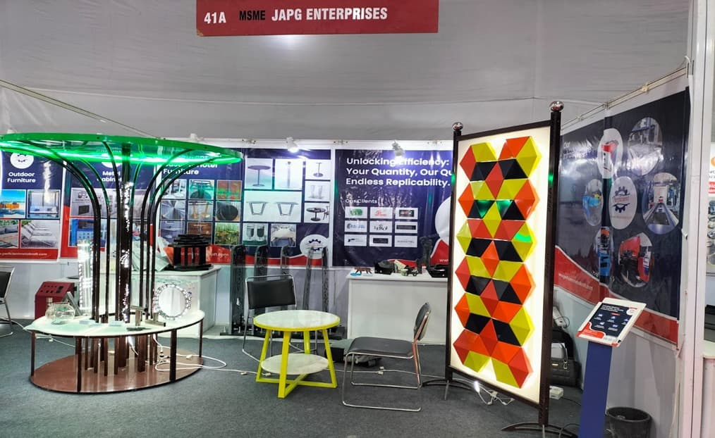 Exhibition booth of JAPG Enterprises showcasing custom metal furniture, decorative panels, and fabrication capabilities.